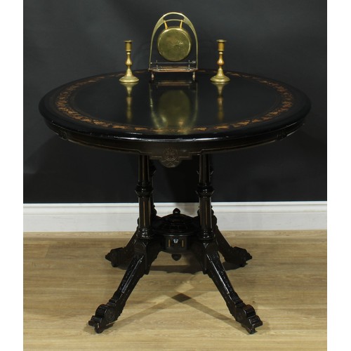 1329 - A late Victorian Aesthetic Movement ebonised and marquetry centre table, oval tilting top inlaid wit... 