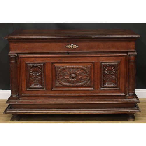 1293 - A late 17th/early 18th century Continental oak chest, hinged top above a three panel front, carved w... 