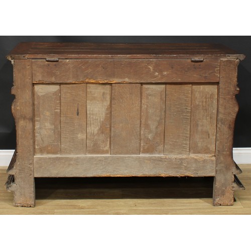 1293 - A late 17th/early 18th century Continental oak chest, hinged top above a three panel front, carved w... 