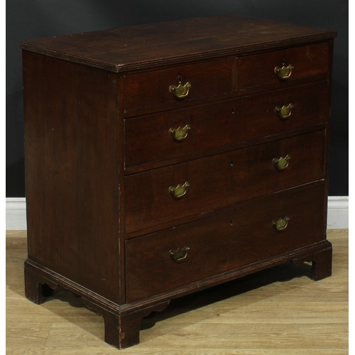 1244 - A George III oak chest, rectangular top with reeded edge above two short and three long graduated dr... 