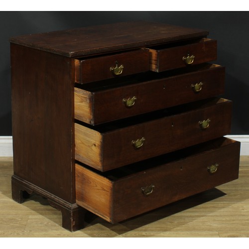 1244 - A George III oak chest, rectangular top with reeded edge above two short and three long graduated dr... 