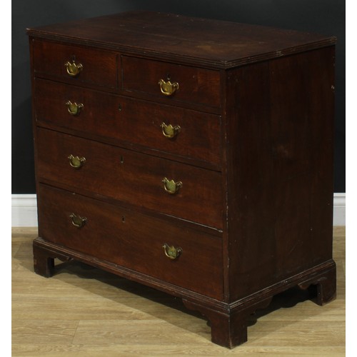 1244 - A George III oak chest, rectangular top with reeded edge above two short and three long graduated dr... 