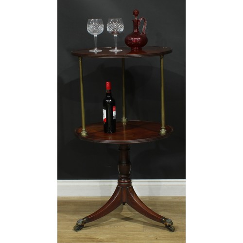 1435 - A Regency mahogany two-tier dumbwaiter, circular plateaux with reeded edge, brass columnar supports,... 