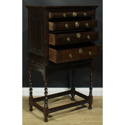 885 - A 17th century style oak bargueño-type chest on stand, rectangular top above four long graduated dra... 