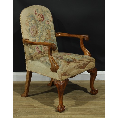 1059 - A George I design walnut open armchair, stuffed-over upholstery, scroll hand rests carved with a she... 