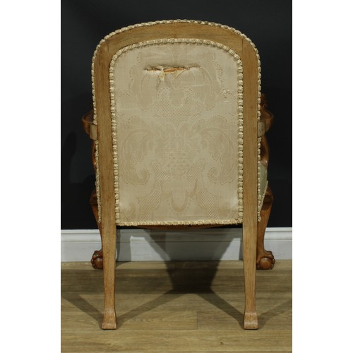 1059 - A George I design walnut open armchair, stuffed-over upholstery, scroll hand rests carved with a she... 