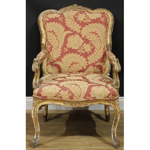 1351 - A Louis XV Revival giltwood fauteuil, in the manner of Blaise Maucuy, stuffed-over upholstery, cabri... 