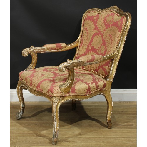 1351 - A Louis XV Revival giltwood fauteuil, in the manner of Blaise Maucuy, stuffed-over upholstery, cabri... 