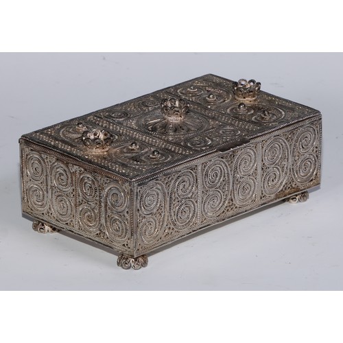 272 - An Eastern rectangular silvered coloured metal filigree casket, the hinged cover and sides decorated... 