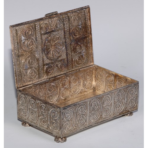 272 - An Eastern rectangular silvered coloured metal filigree casket, the hinged cover and sides decorated... 