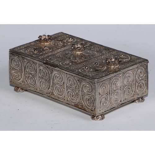 272 - An Eastern rectangular silvered coloured metal filigree casket, the hinged cover and sides decorated... 