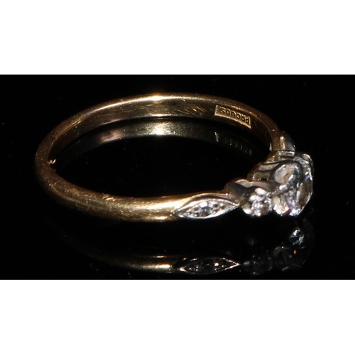 364 - An 18ct gold and platinum three stone diamond ring, diamond chips to navette shaped shoulders, size ... 