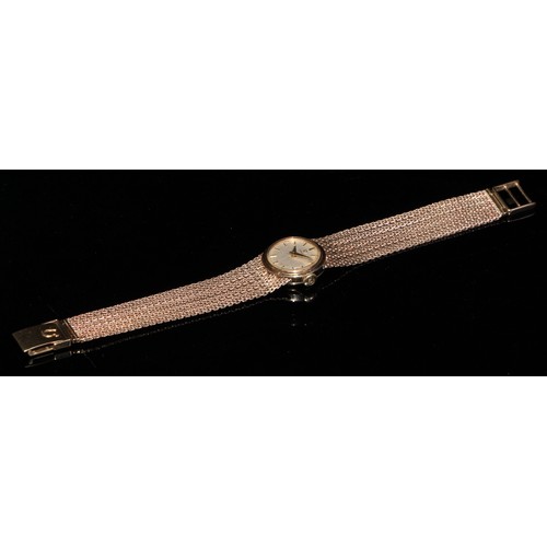 328 - A 9ct gold lady's Omega wristwatch, champagne dial, baton markers, side wind, fine mesh strap, 27g g... 