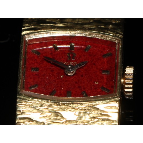 337 - An 18ct gold lady's Omega wristwatch, bowed rectangular claret dial, gold baton markers, integral ba... 