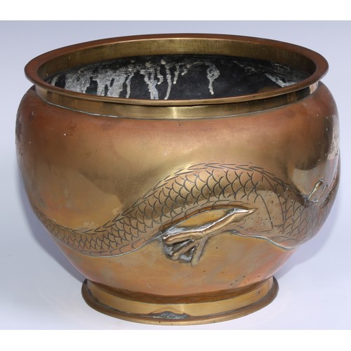 1077 - A Chinese bronze ovoid jardiniere, in relief with a ferocious dragon, 28cm diam, early 20th century