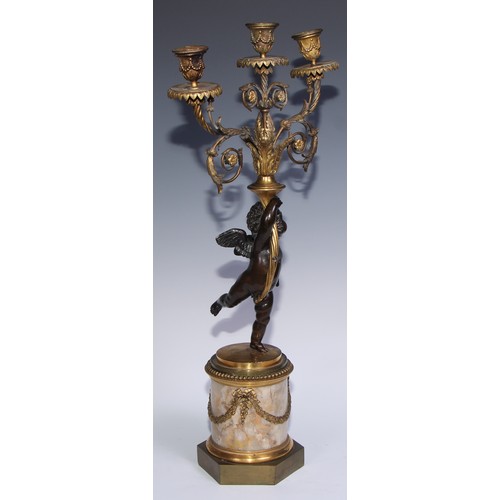 1384 - A pair of 19th century gilt and dark patinated bronze figural three-light candelabra, each cast as a... 