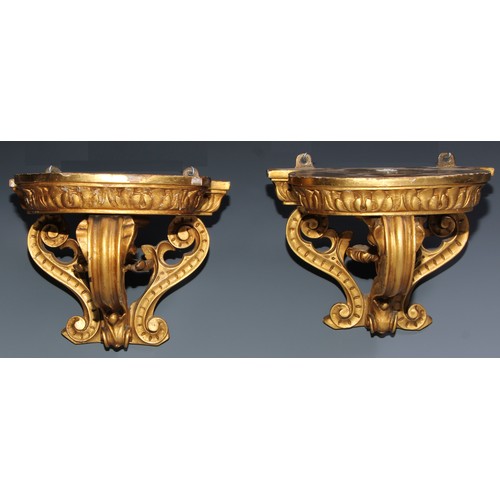 1386 - A pair of 19th century giltwood and gesso wall brackets, bowed plateau with acanthus border, above a... 