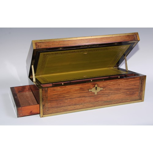 1257 - A large Regency rosewood rectangular campaign writing box, the hinged cover ratchet-adjustable for r... 