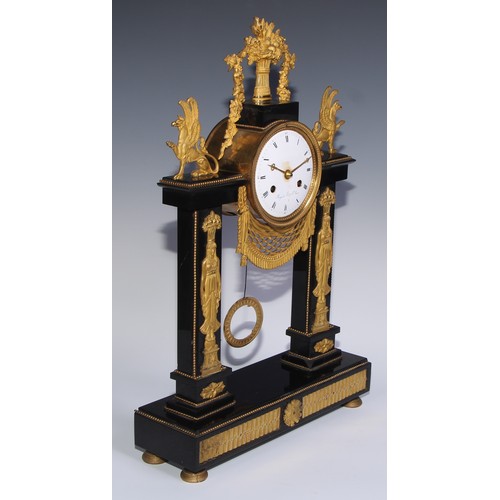 981 - A French Empire gilt bronze mounted black noir marble mantel clock, in the Egyptian Revival taste, 1... 