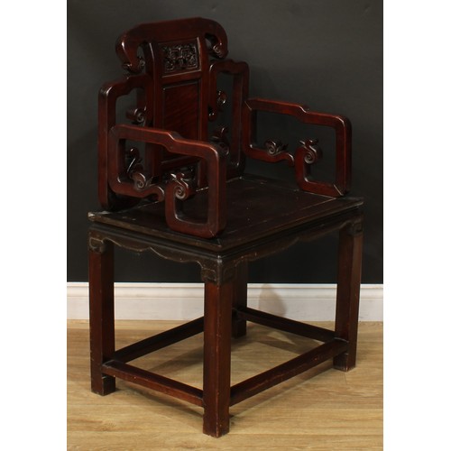 1025 - A Chinese hardwood armchair, shaped back carved with scrolls and set with a panel pierced and carved... 