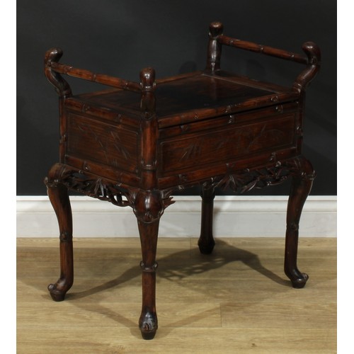 1049 - A Chinese padouk wood piano stool, hinged panel seat, carry handles to sides, carved and incised wit... 