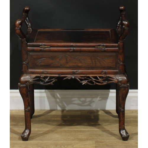 1049 - A Chinese padouk wood piano stool, hinged panel seat, carry handles to sides, carved and incised wit... 