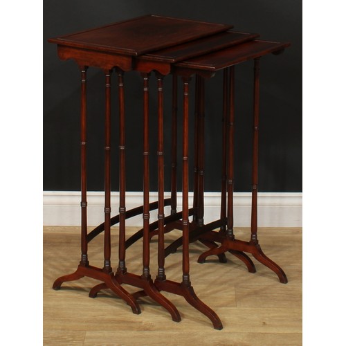 1177 - A George III Revival rosewood nest of three occasional tables, each with a rectangular top and ring-... 