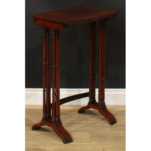 1177 - A George III Revival rosewood nest of three occasional tables, each with a rectangular top and ring-... 