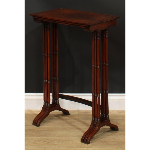 1177 - A George III Revival rosewood nest of three occasional tables, each with a rectangular top and ring-... 