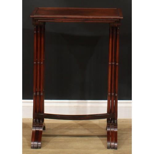 1177 - A George III Revival rosewood nest of three occasional tables, each with a rectangular top and ring-... 