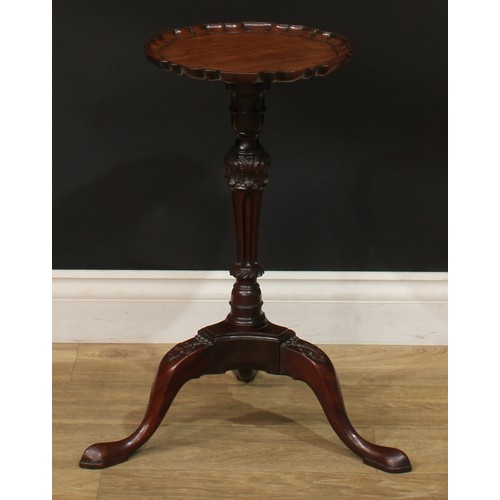 942 - A 19th century mahogany tripod wine table, dished pie crust top, turned and fluted column carved wit... 