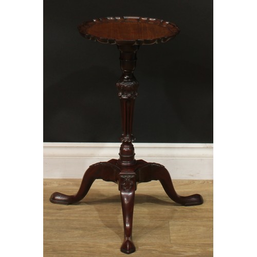 942 - A 19th century mahogany tripod wine table, dished pie crust top, turned and fluted column carved wit... 