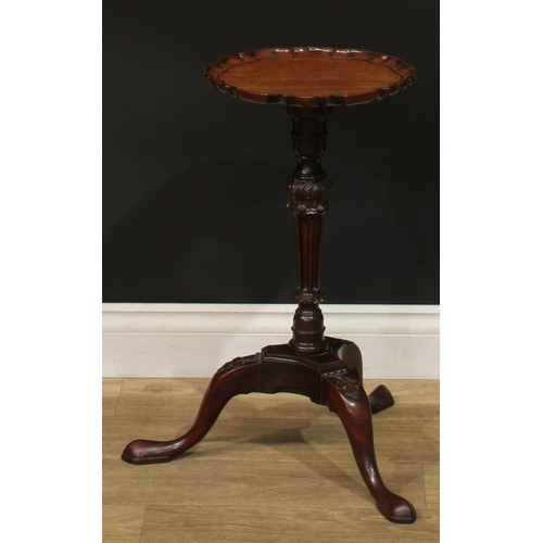 942 - A 19th century mahogany tripod wine table, dished pie crust top, turned and fluted column carved wit... 