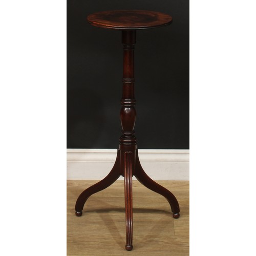 941 - A 19th century mahogany tripod wine table, circular top with channelled edge, turned column, reeded ... 