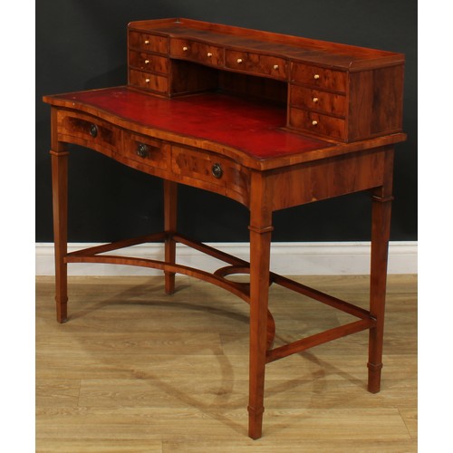 1181 - A George III style yew veneer Carlton House type desk, the superstructure with eight small drawers, ... 