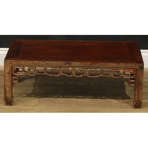 1032 - A Chinese hardwood low kang or tea table, rectangular top, shaped and pierced apron carved with styl... 