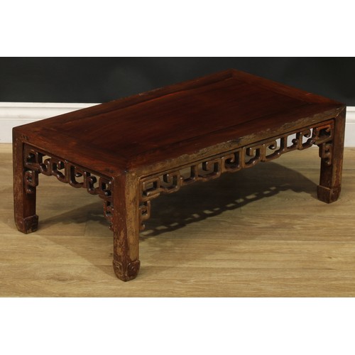 1032 - A Chinese hardwood low kang or tea table, rectangular top, shaped and pierced apron carved with styl... 