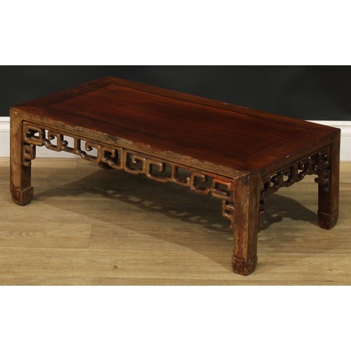 1032 - A Chinese hardwood low kang or tea table, rectangular top, shaped and pierced apron carved with styl... 