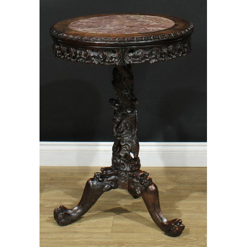 1044 - A Chinese hardwood tripod occasional table, circular top with inset marble panel above a shaped frie... 