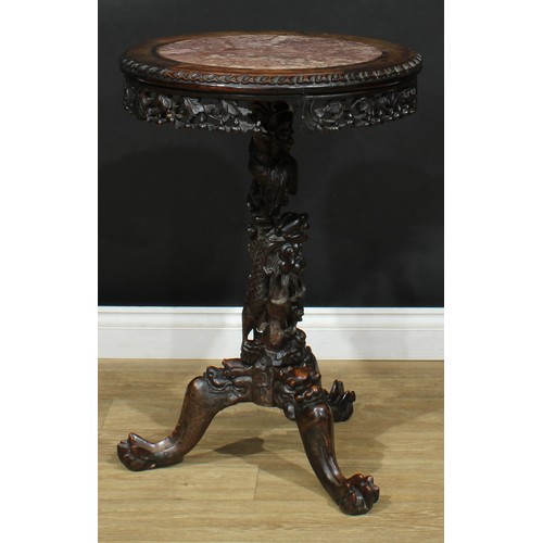 1044 - A Chinese hardwood tripod occasional table, circular top with inset marble panel above a shaped frie... 