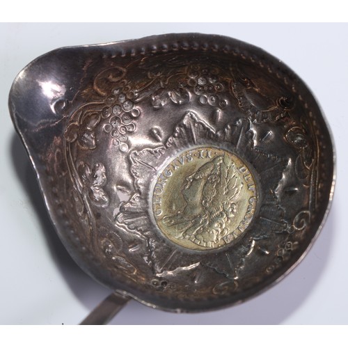 118 - A George III silver coloured metal toddy ladle, the bowl chased with fruiting vine and set with a gi... 