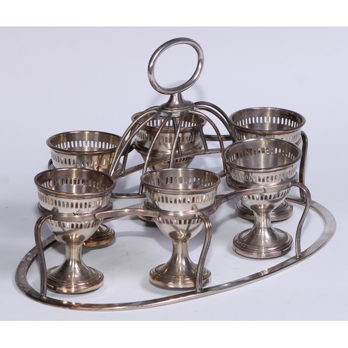 11 - A George III Old Sheffield Plate oval six-cup egg cruet, lofty loop handle, 22.5cm wide, c.1805