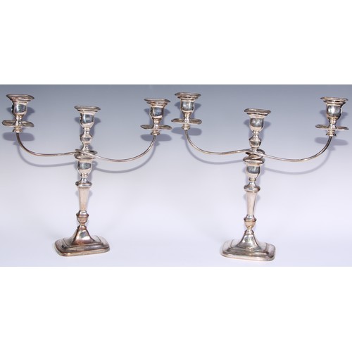 26 - A pair of George III Old Sheffield Plate three-light table candelabra, rectangular campana sconces, ... 