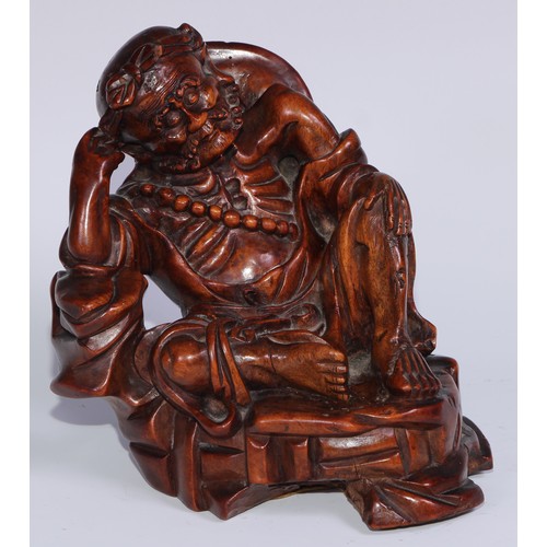 796 - A Chinese hardwood carving, of a monk, reclining, wearing a string of prayer beads, 16.5cm high, ear... 