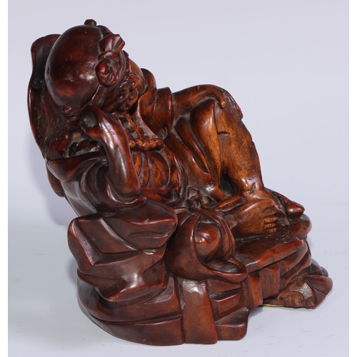 796 - A Chinese hardwood carving, of a monk, reclining, wearing a string of prayer beads, 16.5cm high, ear... 