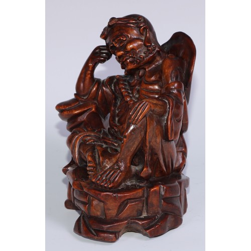 796 - A Chinese hardwood carving, of a monk, reclining, wearing a string of prayer beads, 16.5cm high, ear... 