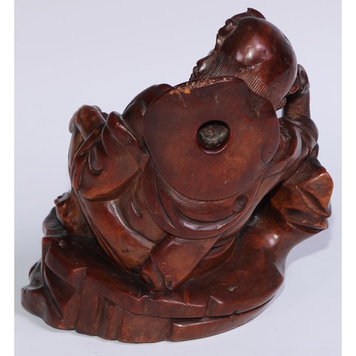 796 - A Chinese hardwood carving, of a monk, reclining, wearing a string of prayer beads, 16.5cm high, ear... 