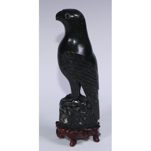 807 - A pair of Chinese jade carvings, of parrots, hardwood stands, 26.5cm high overall, 19th/early 20th c... 