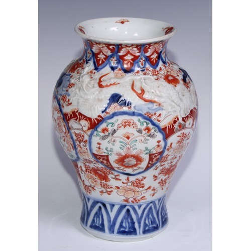 756 - A Japanese ovoid vase, moulded with dragons and painted in the Imari palette, 30cm high, Meiji perio... 