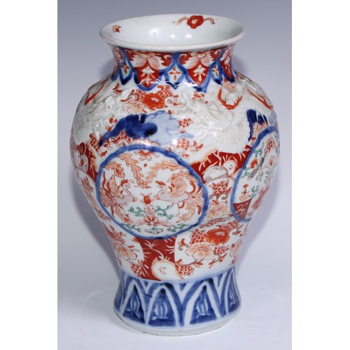 756 - A Japanese ovoid vase, moulded with dragons and painted in the Imari palette, 30cm high, Meiji perio... 